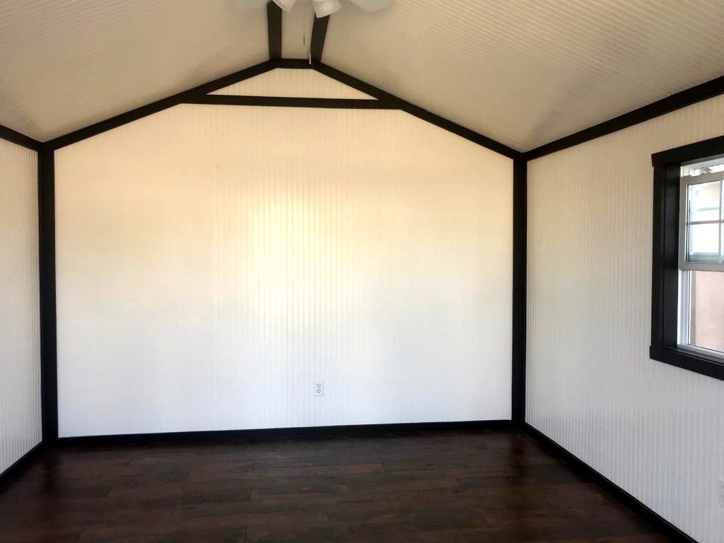 White beadboard walls with black trim and dark wood floor
