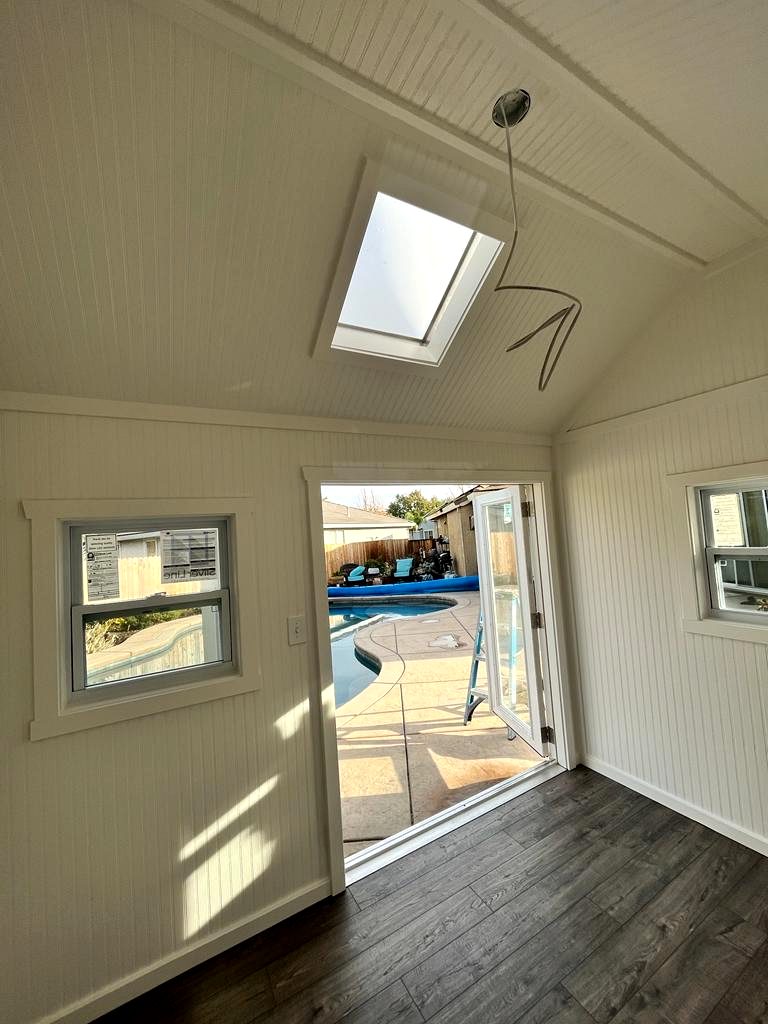Poolside studio with skylight, beadboard walls and open French door