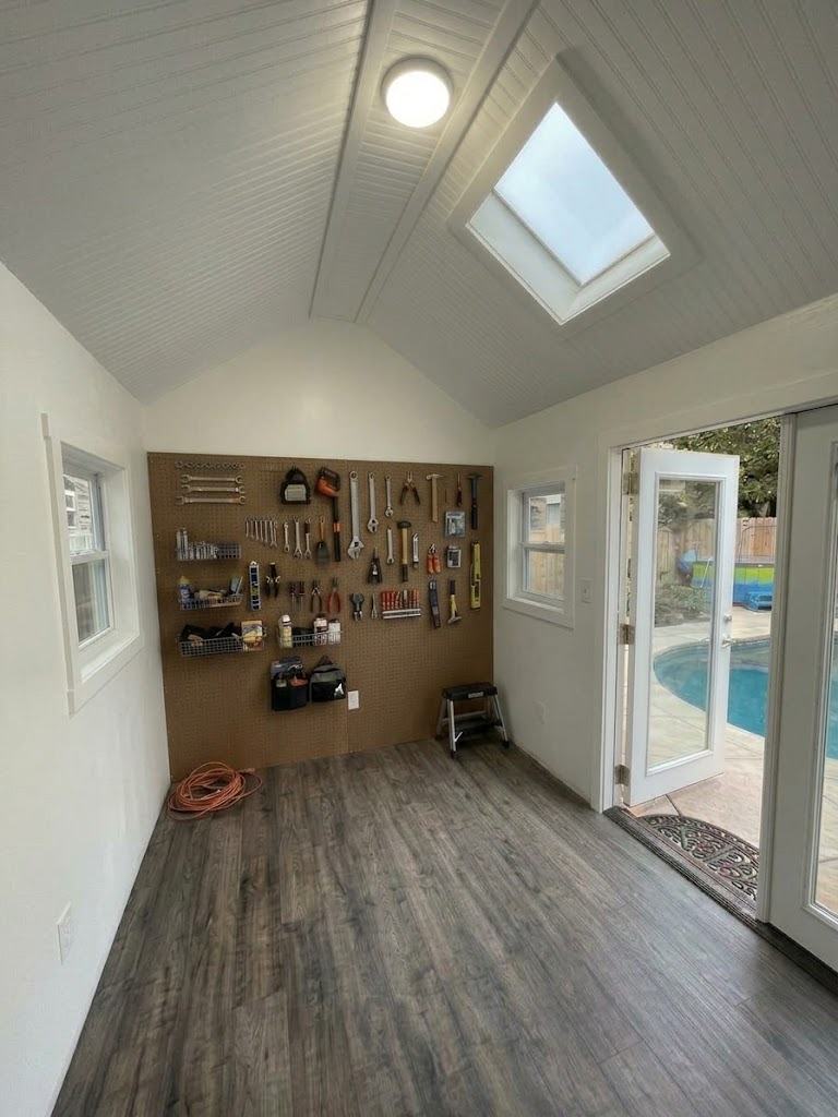 Silver interior with pegboard tool wall, vaulted ceiling and French doors